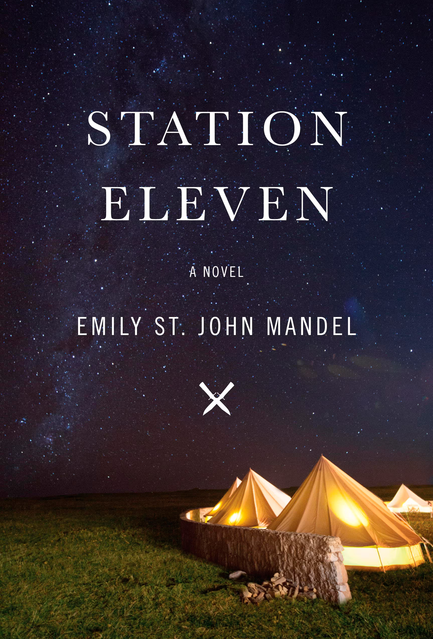 Book cover of Station Eleven by Emily St. John Mandel shows a campsite of tents lit by lights, and they all sit below a dark starry sky.